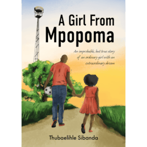 A girl walking down a dirt road, holding her fathers hand while her father holds a soccer ball in his other hand